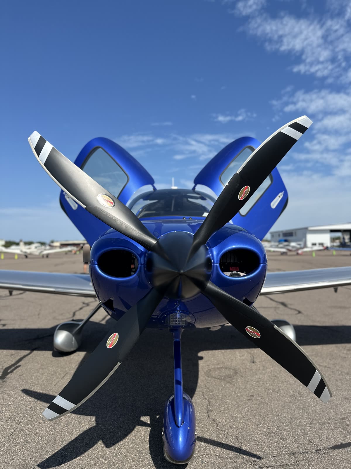Nose to nose with a blue Cirrus SR, propeller blades crossed in front